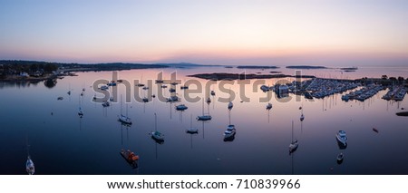 Aerial view on the boats parked at the marina during a colorful morning sunrise. Picture taken in the capital city of Victoria, Vancouver Island, British Columbia, Canada.