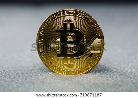 Photo of golden bitcoin (new virtual currency) on black background.