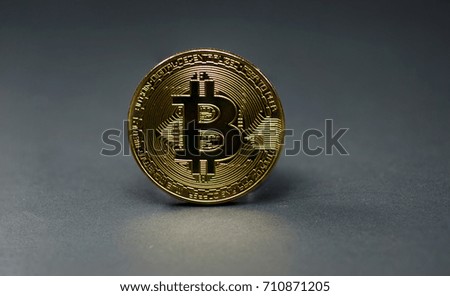 Photo of golden bitcoin (new virtual currency) on black background.