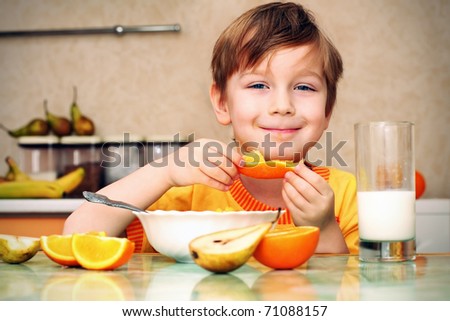 boy, breakfast, drinks milk, eats cereal and orange