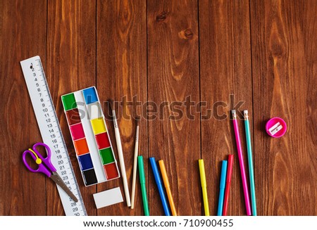 back to school styled pattern with bright school supplies on wooden background copy space 