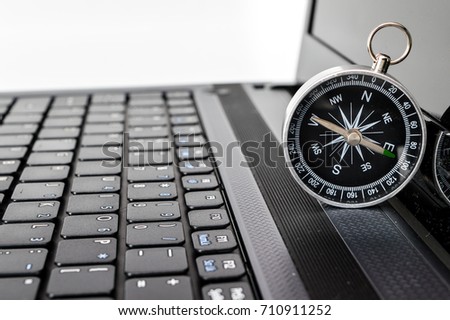  Navigation on the Internet! Photo of magnetic compass on computer keyboard.