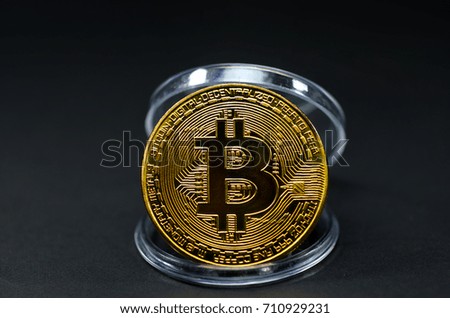 Photo of golden bitcoin (new virtual currency) with black background.