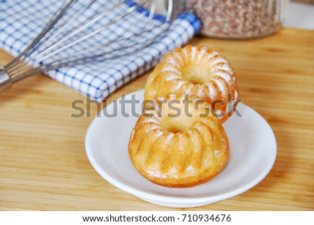 sweet muffins with icing sugar and a glass of milk