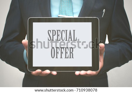 Special offer.  Business man holding in his hands tablet computer with inscription "Special offer".