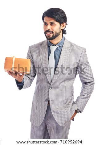 Studio shot of young businessman presenting gift bow on white. 