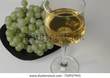 Wine and Grapes. Young White Wine and Green Grapes isolated on White Background