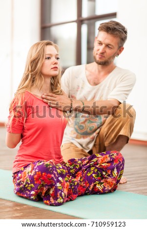 Yoga instructor teaching a woman