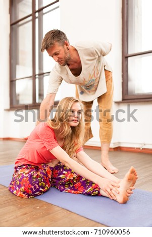 Yoga instructor teaching a woman