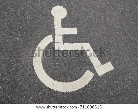 Handicapped disability parking painted sign.