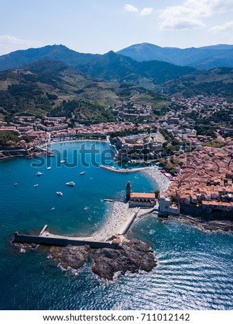 the city of collioure with the port and boats from the air in the mediteranean sea over the water with and aerial point of view 