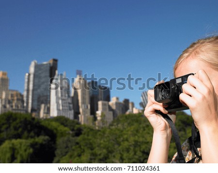 Woman taking pictures in central park
