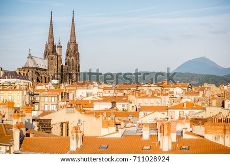 Morning aerial cityscape view on Clermont-Ferrand city with beautiful cathedral and mountains on the background in central France Royalty-Free Stock Photo #711028924