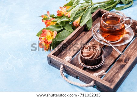Picture of black tea in cup, cake