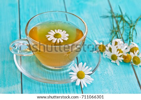  Chamomile tea. Camomile flower and cup of camomile tea.