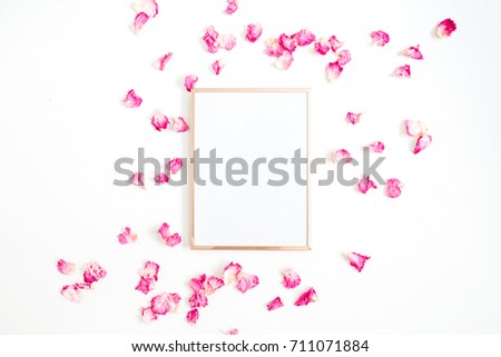 Photo frame mock up with space for text and pink rose petals on white background. Flat lay, top view. Valentine's minimal background.
