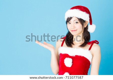 portrait of asian santa claus woman isolated on blue background