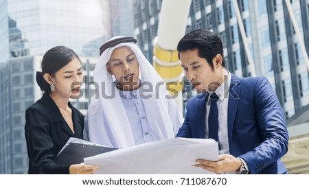 team asian business people smart man and woman talk and present the project  with paper file at outdoor pedestrian walk way the city space modern building