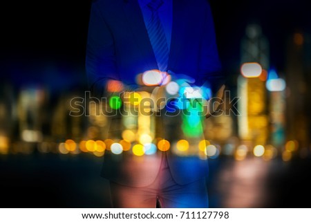 Double exposure of businessman and Blurred Hong Kong city view