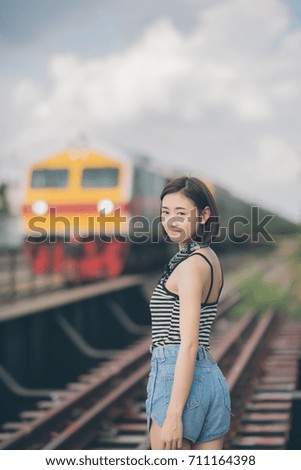 Picture of young woman walk on the railway and smile. Freedom concept vintage tone.