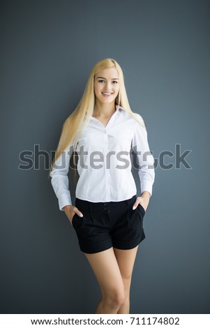 Portrait of wonderful young business woman on gray background with copy space