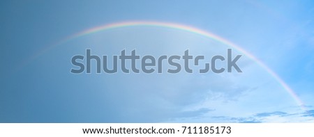 Real rainbow on blue sky after raining.