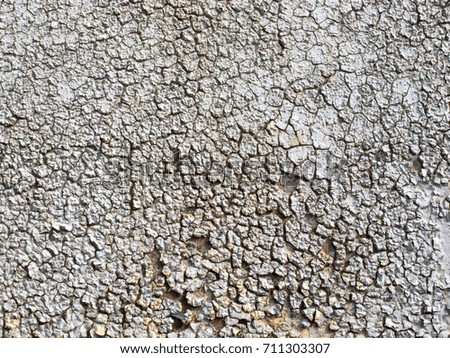 Rusty iron sheet with a thick layer of cracked paint. Metal texture with scratches and cracks. Attrition. Corrosion. Oxidation. Pattern, texture of dried cracked earth in a drought. Gray background.