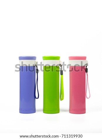 Thermos bottle set isolated on white background. Coffee or tea reusable bottle container. Thermos travel tumbler. Insulated drink container. Purple, green, and pink thermos water flask. Zero waste.