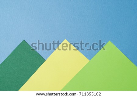 Color papers geometry flat composition background with a yellow , green and blue tones