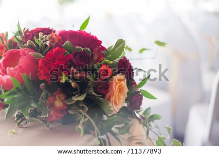 Wedding decor. Red Flowers in the restaurant, soft picture