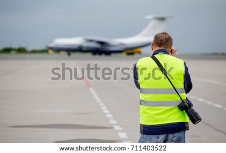 Planespotter make a photo of the airplane. Modern commercial passenger plane on background.