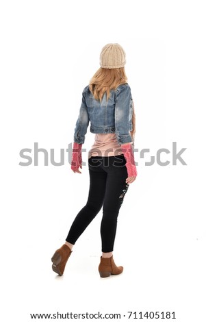 full-length portrait of woman wearing fall fashioned clothing. standing pose on white background
