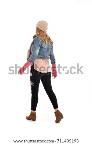 full-length portrait of woman wearing fall fashioned clothing. standing pose on white background