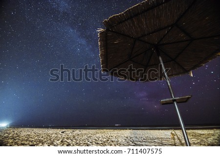 starry sky sea and umbrella