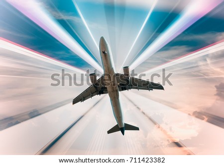 Big airplane taking up motion on bright divergent rays background