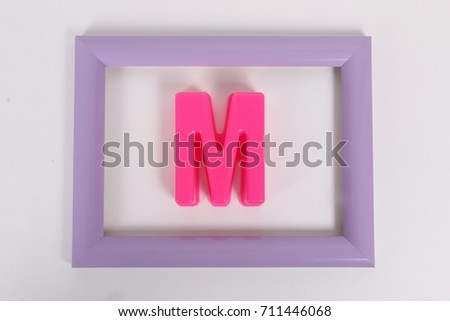 letter m in a picture frame in the studio