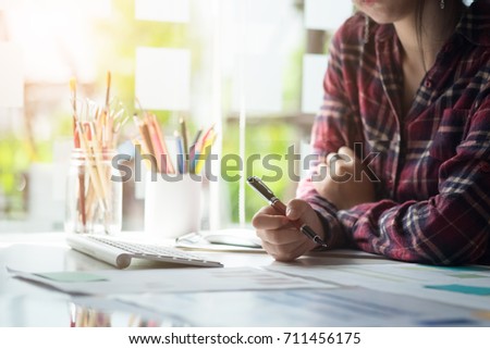 Creative woman working in creative office with computer and gadget or device on artist desk, graphic design concept.