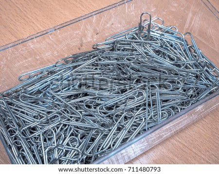 Paper clip in clear box on the table 