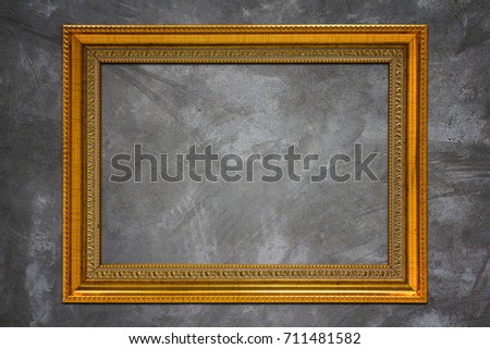 Golden wood frame on concrete texture background, luxury concept