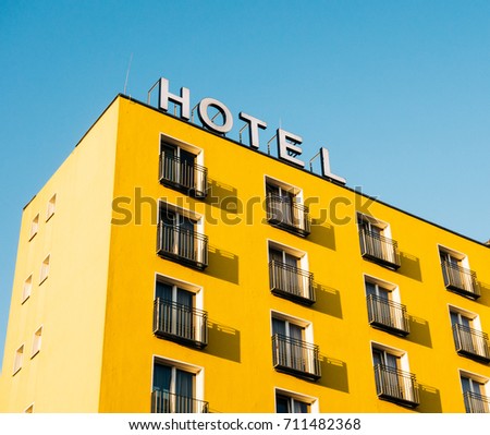 yellow building with hotel sign