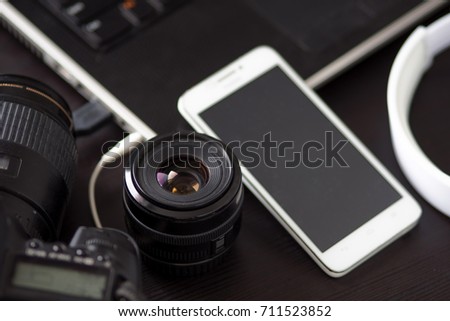 DSLR camera and a mobile phone with built-in camera, for creating and editing photos