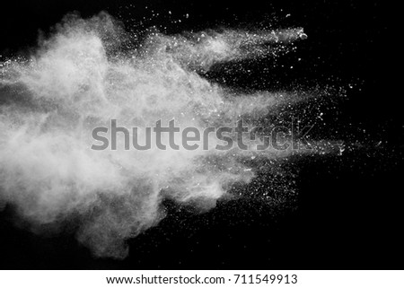 Stopping the movement of white powder on dark background.
