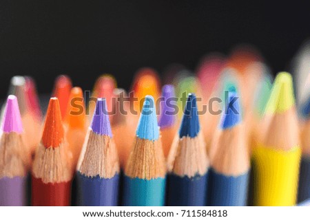Group of color pencil on black background.