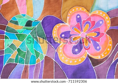 textile background - hand drawn stylized flower and leaf on silk batik scarf