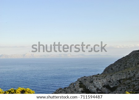 Majorca,Spain. On the horizon of the sea merges with the sky. The boundless deep blue sea. Expansive deep blue empty ocean seascape with layer of gray clouds forming along horizon in distance.