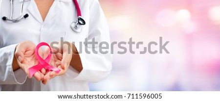 Doctor Hands Holding Pink Cancer Awareness Ribbon
 Royalty-Free Stock Photo #711596005