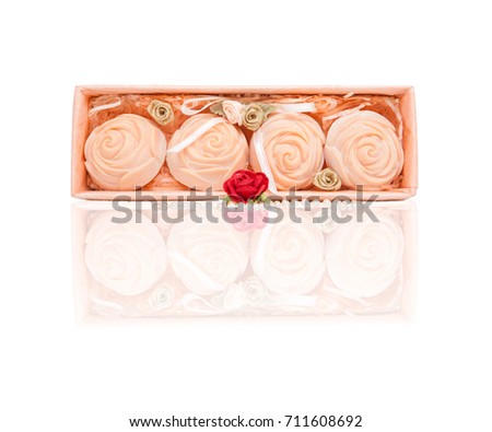 Isolate and clipping path, Four pink roses made of soap of Packed in clear plastic box and Pearl necklace, small golden roses put of inside