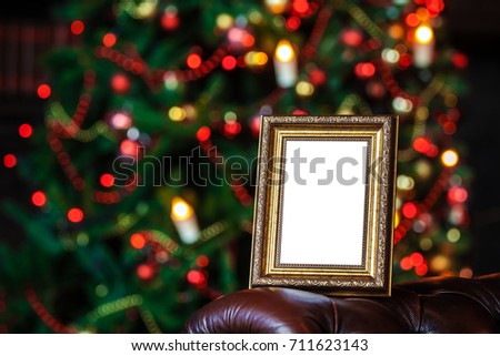 Empty blank photo frame in christmas decorated defocused background with toys lights