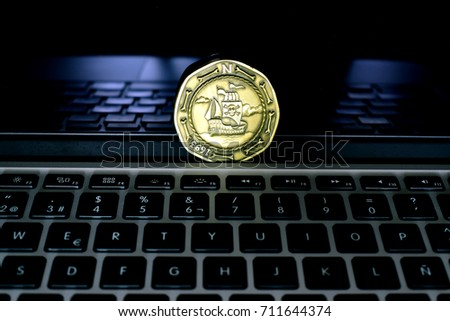 Laptop with pirate coin over screen