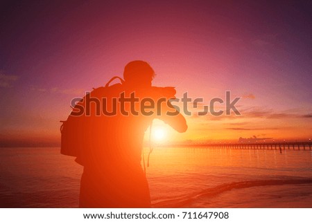 Photographer silhouette at beautiful sunrise.